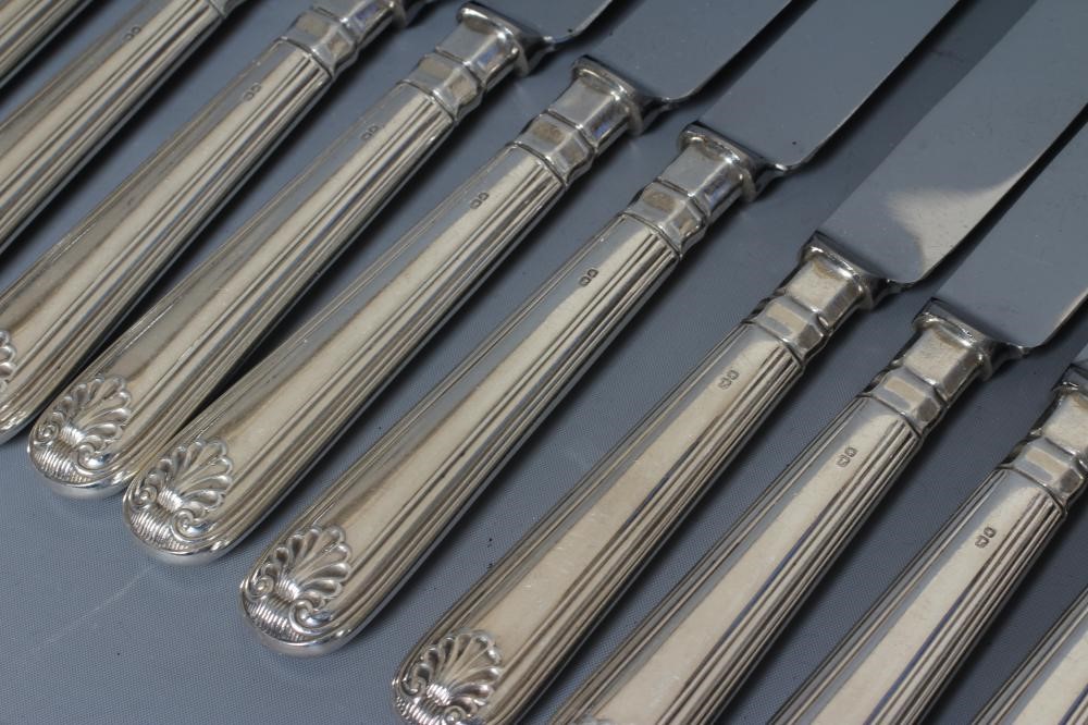 AN ELIZABETH II SET OF TWELVE EACH SILVER SHELL PATTERN TABLE AND DESSERT KNIVES by William Yates, Image