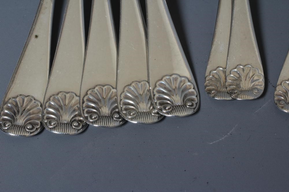 A SET OF TWELVE LATE VICTORIAN SILVER SHELL PATTERN TABLE SPOONS AND DESSERT SPOONS AND FORKS by Image