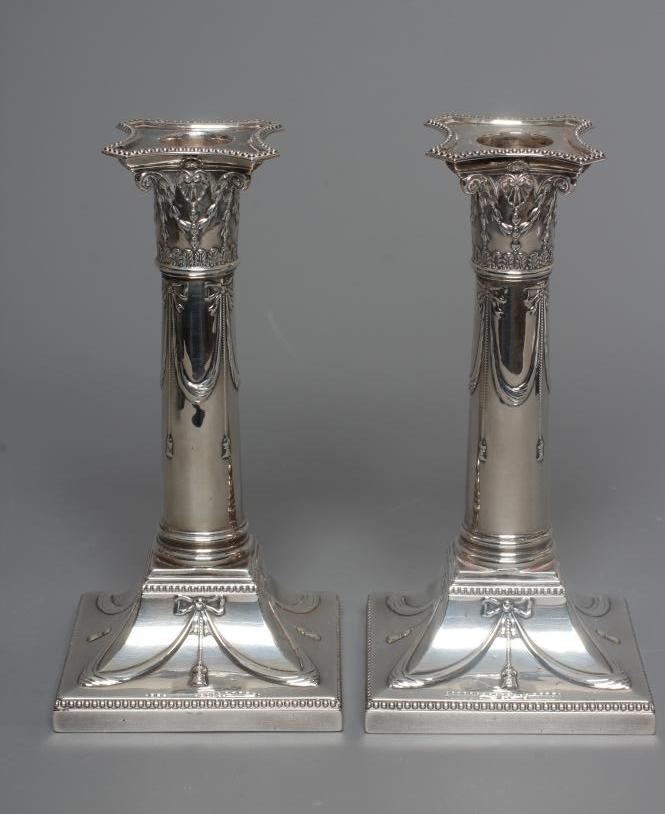 A PAIR OF EDWARDIAN SILVER SMALL CORINTHIAN COLUMN CANDLESTICKS by Thomas Bradbury Image