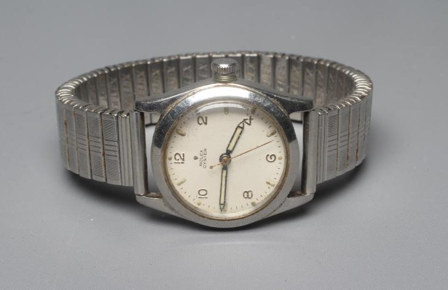 A ROLEX JUNIOR OYSTER WRISTWATCH, the white dial with applied gilt metal Arabic even numerals, in a Image
