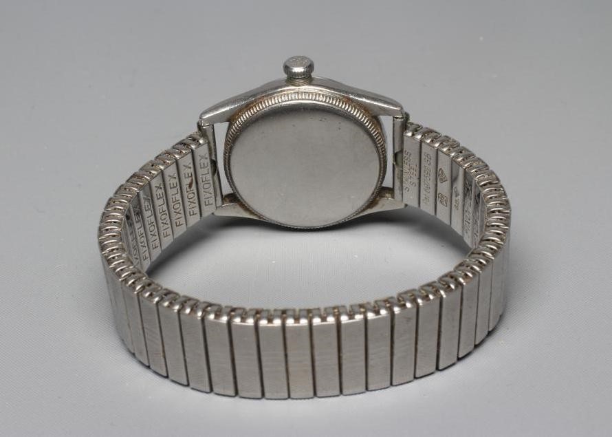 A ROLEX JUNIOR OYSTER WRISTWATCH, the white dial with applied gilt metal Arabic even numerals, in a Image