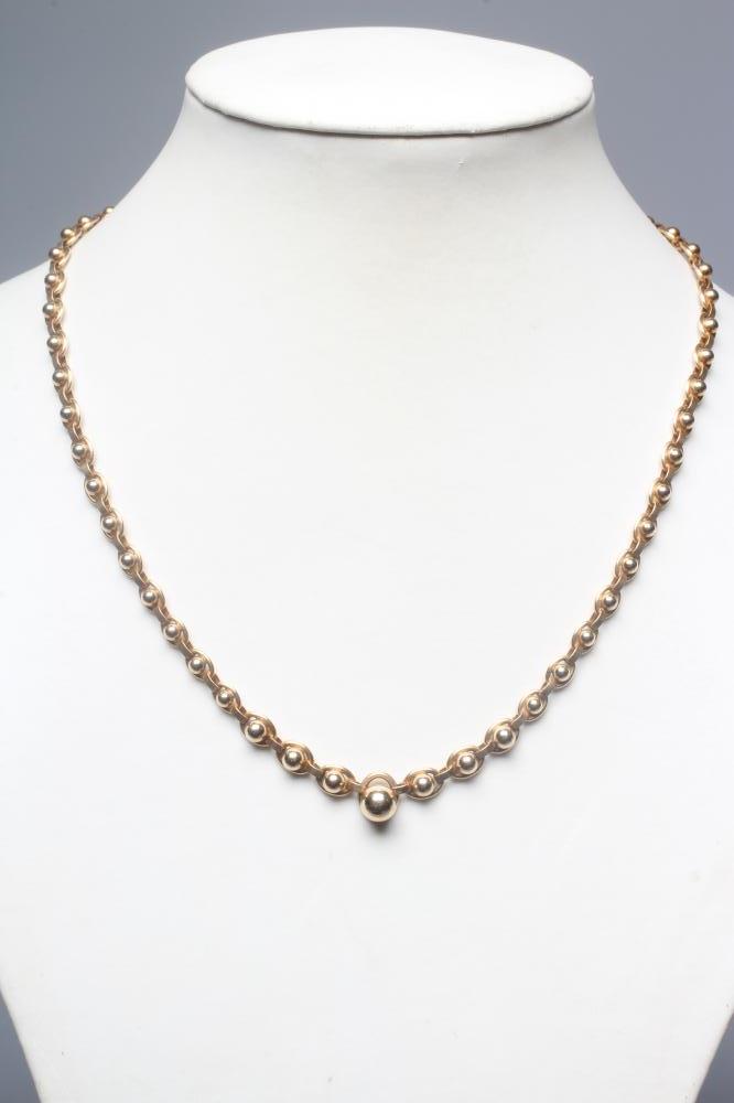 A FANCY LINK CHAIN NECKLACE stamped 375 9, 9K, the ball centred oval links terminating in a larger Image