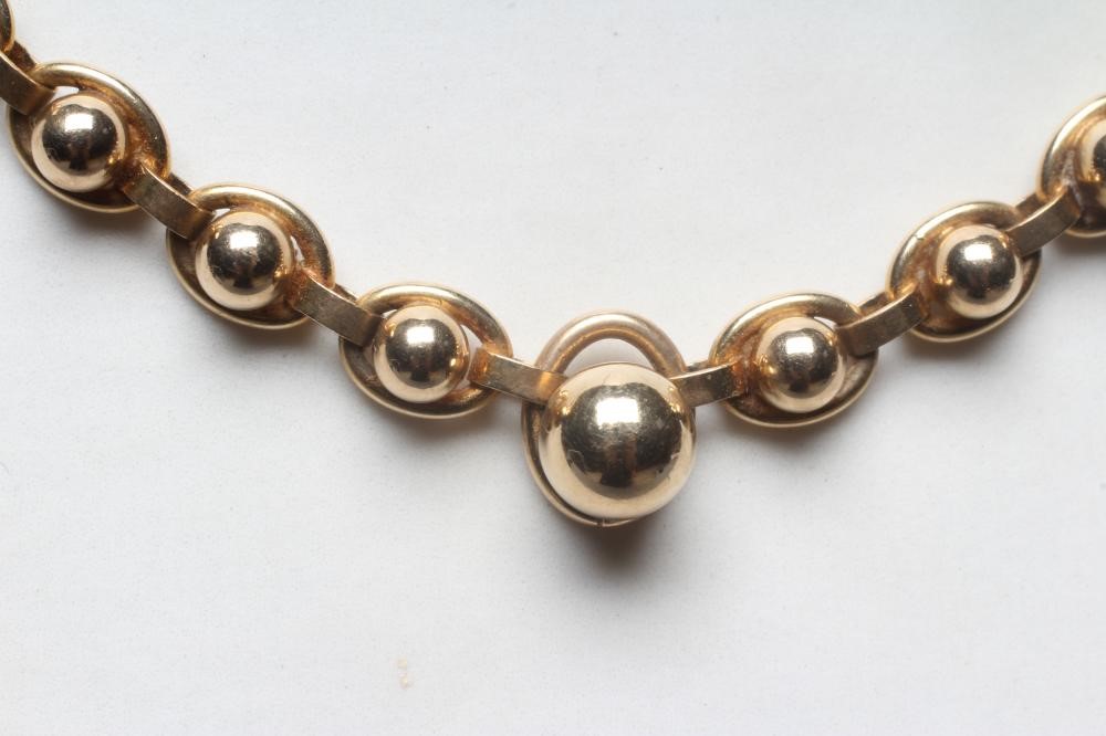A FANCY LINK CHAIN NECKLACE stamped 375 9, 9K, the ball centred oval links terminating in a larger Image