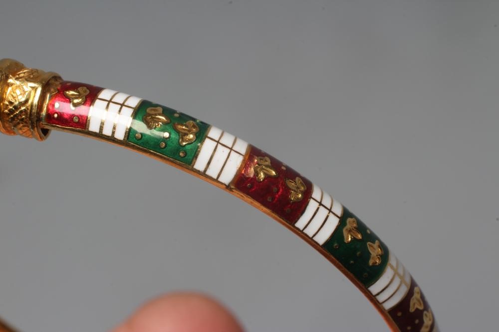 A BANGLE, unmarked but similar to previous lot with red, white and green enamelled arcading and Image