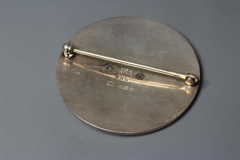 A GEORG JENSEN SILVER CIRCULAR BROOCH designed by Arno Malinowski with a merman riding on the back Image