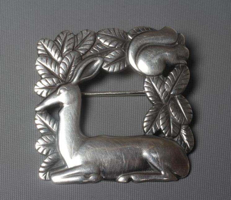 A GEORG JENSEN SILVER SQUARE BROOCH designed by Arno Malinowski with a recumbent deer and squirrel, Image