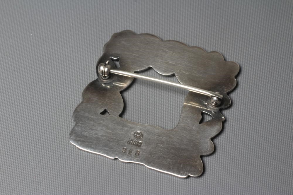 A GEORG JENSEN SILVER SQUARE BROOCH designed by Arno Malinowski with a recumbent deer and squirrel, Image