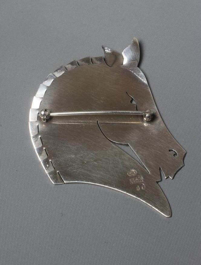 A GEORG JENSEN SILVER HORSE HEAD BROOCH designed by Arno Malinowski, stamped Sterling 90 (Est. plus Image