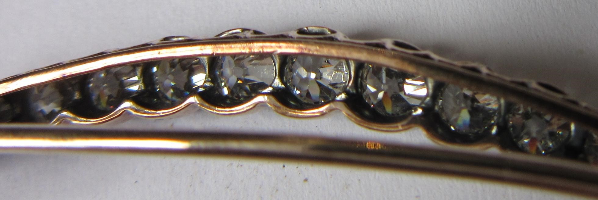 A DIAMOND CRESCENT BROOCH, with twenty old brilliant and five rose cut stones all claw set to an Image