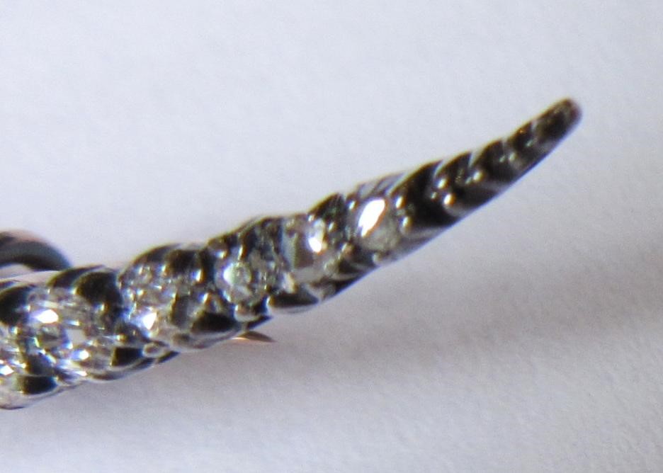 A DIAMOND CRESCENT BROOCH, with twenty old brilliant and five rose cut stones all claw set to an Image