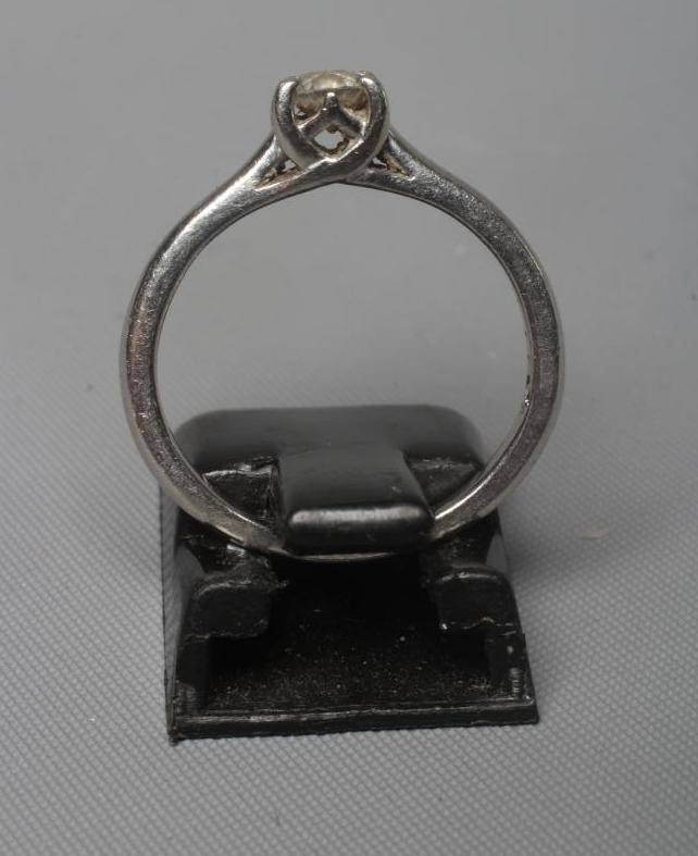 A SOLITAIRE DIAMOND RING, the brilliant cut stone of approximately 0.25cts claw set to a plain Image