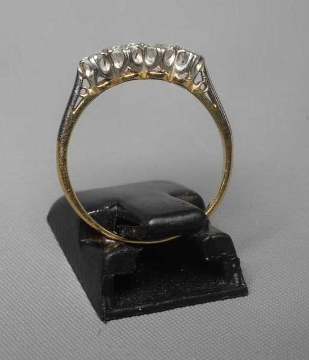 A FOUR STONE DIAMOND RING, the graduating old cut stones totalling approximately 0.50cts claw set to Image