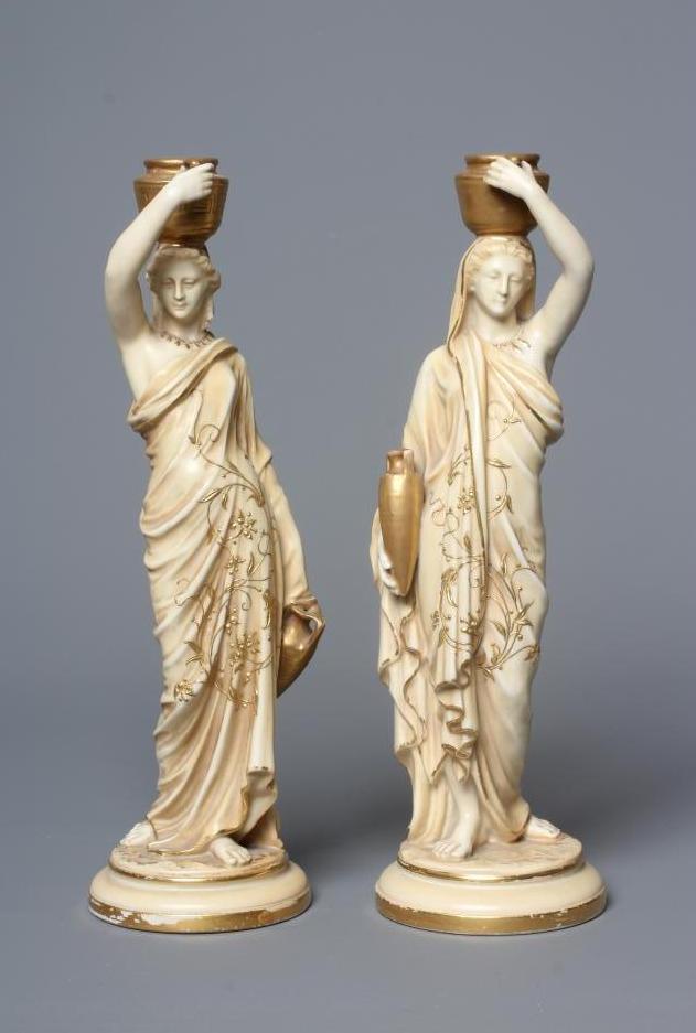 A PAIR OF ROYAL WORCESTER PORCELAIN FIGURES OF WATER CARRIERS Image