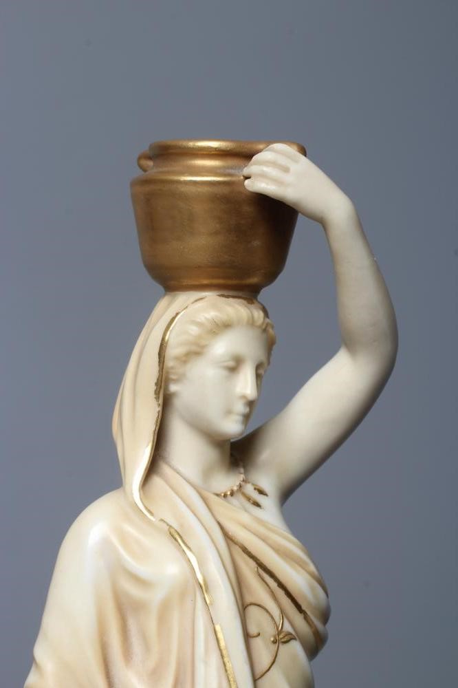 A PAIR OF ROYAL WORCESTER PORCELAIN FIGURES OF WATER CARRIERS Image