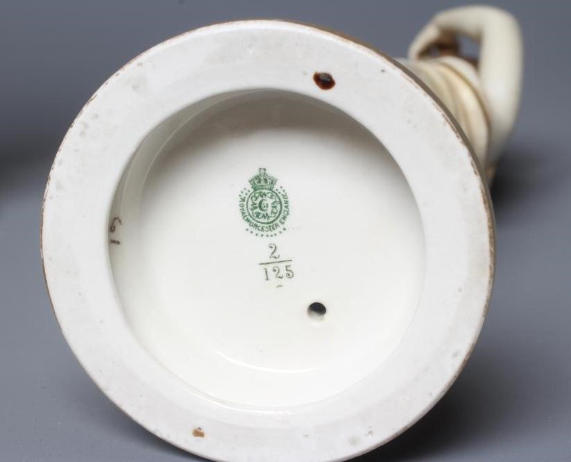 A PAIR OF ROYAL WORCESTER PORCELAIN FIGURES OF WATER CARRIERS Image