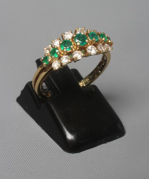 AN EMERALD AND DIAMOND RING Image