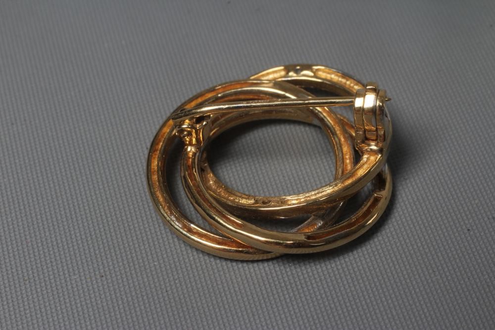 A 9CT BI-COLOUR GOLD TRIPLE CIRCLET BROOCH, the white gold circle pave set with five small brilliant Image