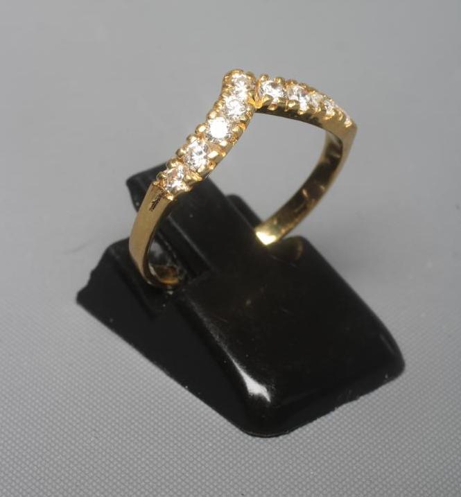 A DIAMOND WISHBONE RING claw set with nine round brilliants to a plain shank stamped 18ct, size N Image