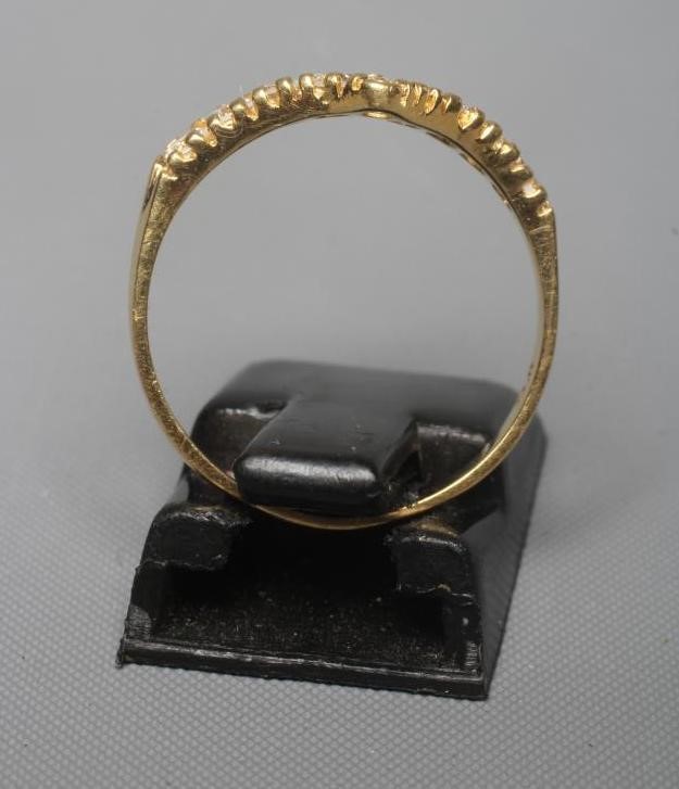 A DIAMOND WISHBONE RING claw set with nine round brilliants to a plain shank stamped 18ct, size N Image