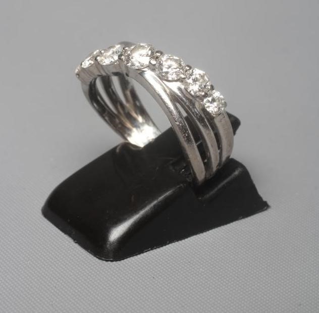 A SEVEN STONE DIAMOND RING, the graduated brilliant cut stones claw set to a triple crossover style Image