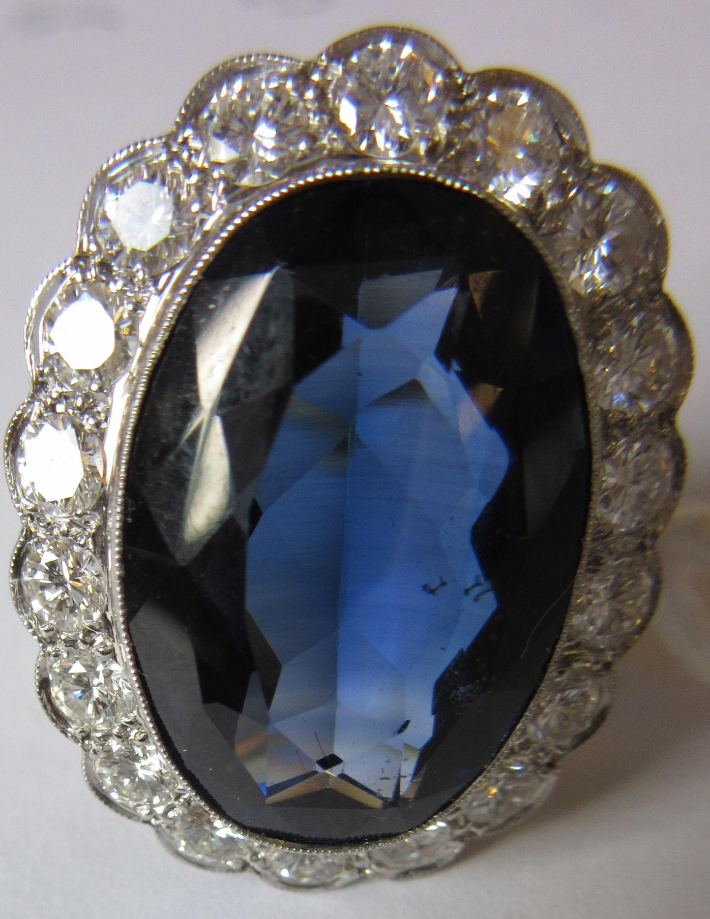 A SAPPHIRE AND DIAMOND CLUSTER RING Image
