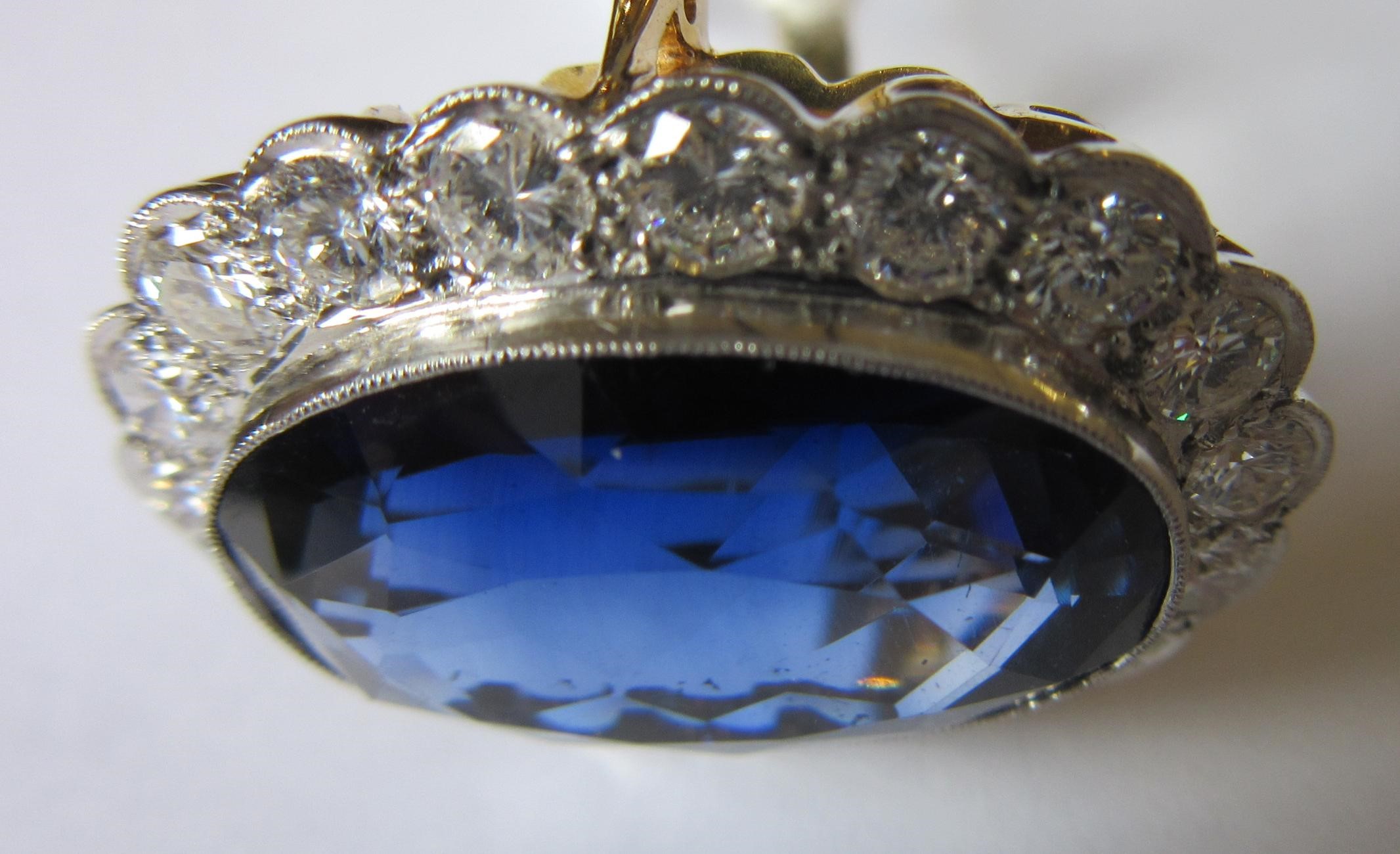 A SAPPHIRE AND DIAMOND CLUSTER RING Image