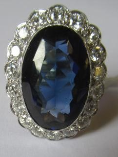 A SAPPHIRE AND DIAMOND CLUSTER RING Image