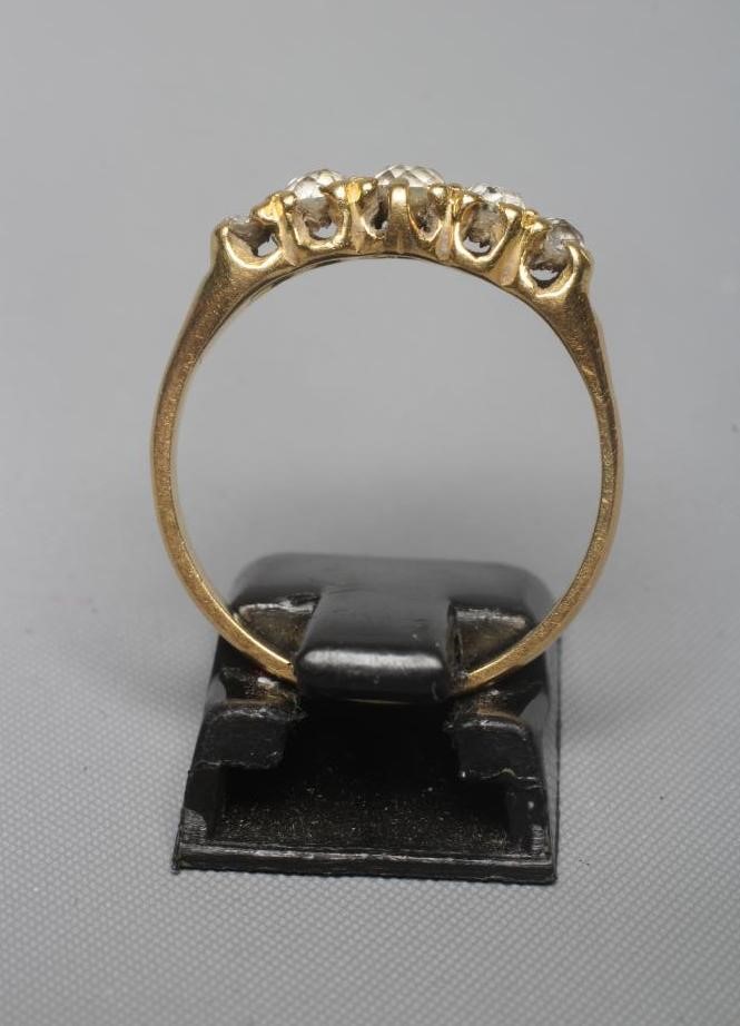 A FIVE STONE DIAMOND RING, the old cut stones claw set to a plain unmarked shank, size Q (Est. plus Image