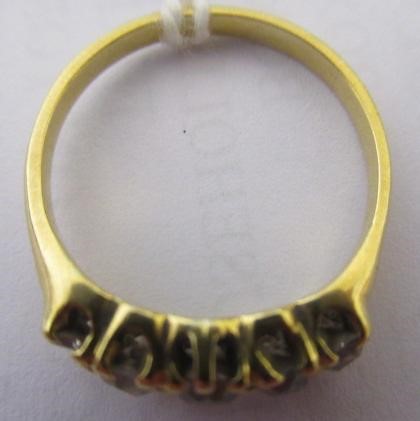 A FIVE STONE DIAMOND RING, the old cut stones claw set to a plain unmarked shank, size Q (Est. plus Image