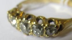 A FIVE STONE DIAMOND RING, the old cut stones claw set to a plain unmarked shank, size Q (Est. plus Image
