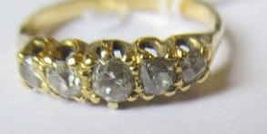 A FIVE STONE DIAMOND RING, the old cut stones claw set to a plain unmarked shank, size Q (Est. plus Image