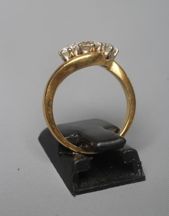 A THREE STONE DIAMOND CROSSOVER RING, the central old brilliant cut stone of approximately 0.5cts, Image