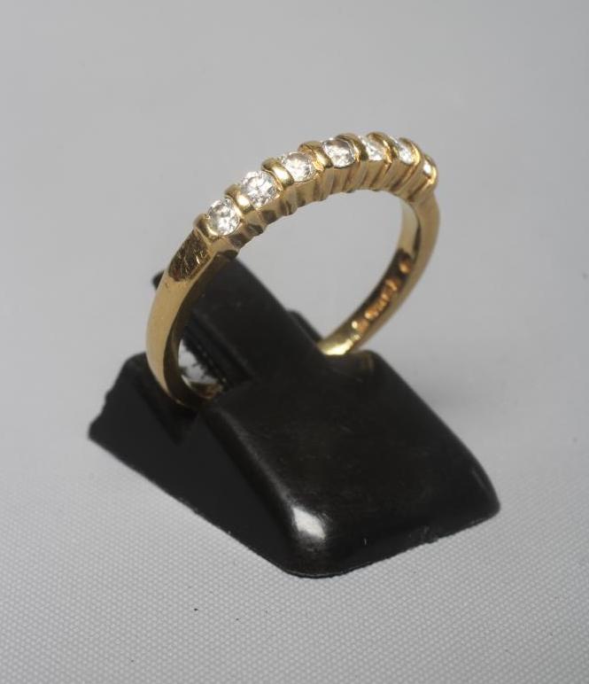 A SEVEN STONE DIAMOND RING, the brilliant cut stones each of approximately 0.40cts, line set to a Image