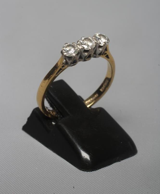 A THREE STONE DIAMOND RING, the brilliant cut stones each of approximately 0.25cts, claw set to a Image