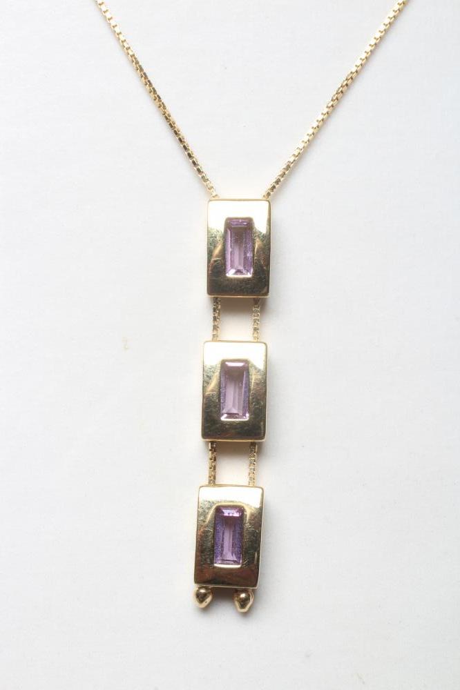 A MODERN AMETHYST PENDANT, the three oblong facet cut stones in plain block rub-over settings fixed Image
