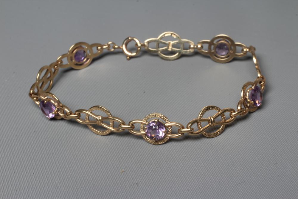 AN AMETHYST BRACELET, the five circular facet cut stones claw set to a Celtic knot type design Image