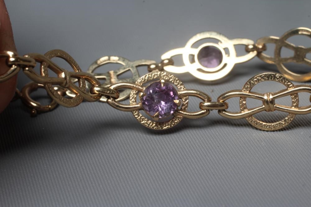 AN AMETHYST BRACELET, the five circular facet cut stones claw set to a Celtic knot type design Image