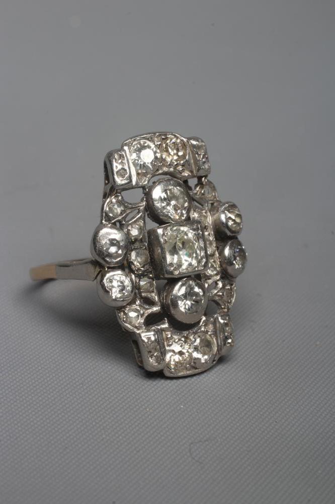 AN ART DECO PLAQUE RING, the numerous mix cut stones in rub-over and claw settings to a plain 18ct Image