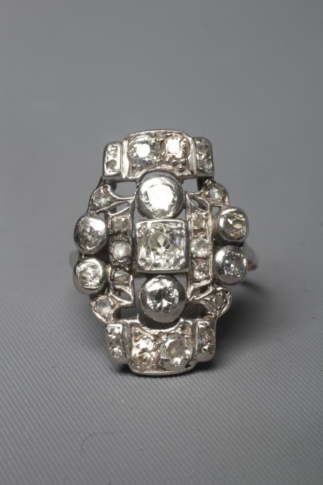 AN ART DECO PLAQUE RING, the numerous mix cut stones in rub-over and claw settings to a plain 18ct Image