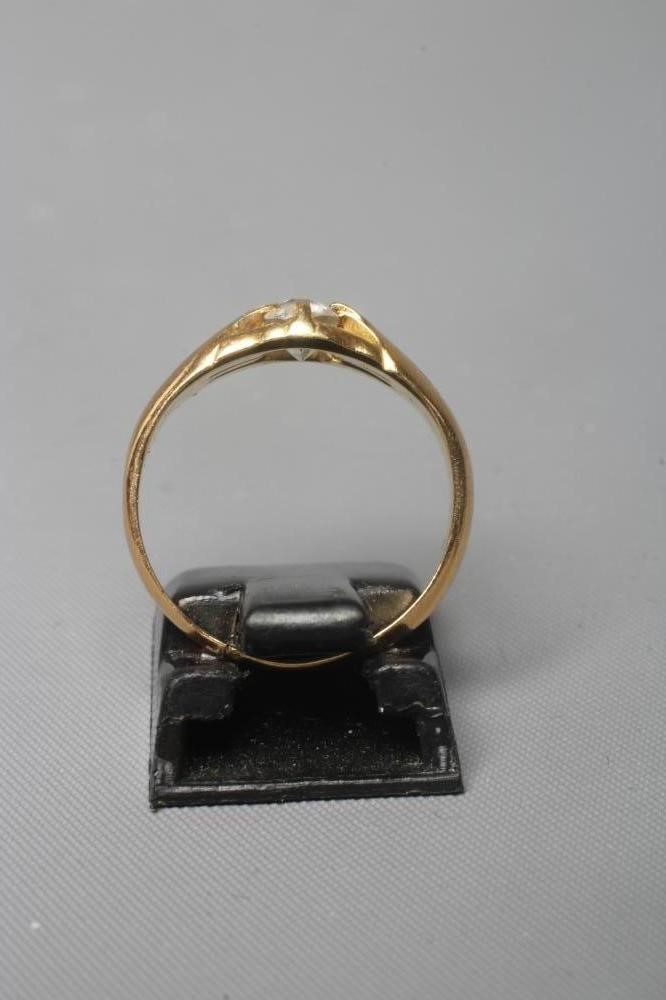 A DIAMOND SIGNET RING, the old cut stone of approximately 0.25cts, claw set to reeded shoulders and Image