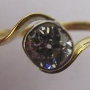 A SOLITAIRE DIAMOND RING, the old cut stone of approximately 0.5cts in a cross over setting to a Image