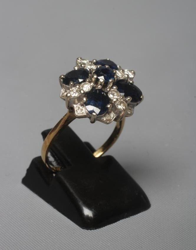 A SAPPHIRE AND DIAMOND CLUSTER RING Image