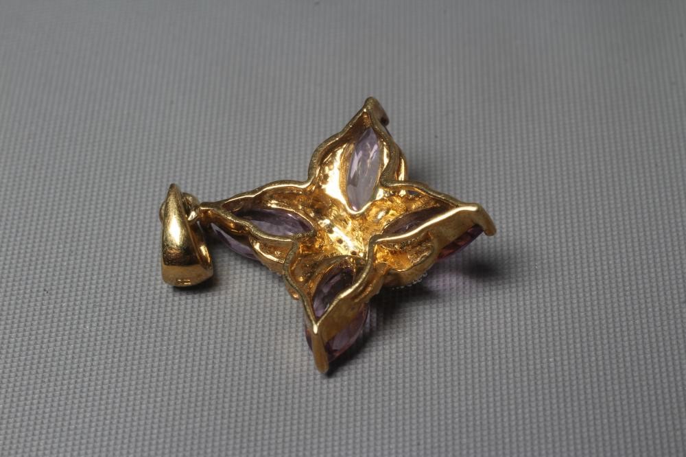 AN AMETHYST AND DIAMOND PENDANT, the four marquise cut amethysts claw set with pave diamond set Image