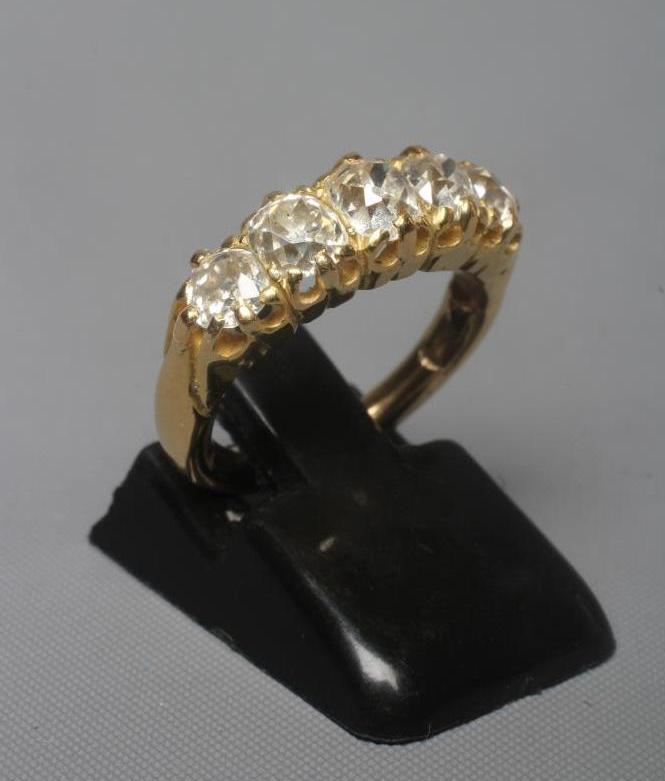 A FIVE STONE DIAMOND HALF HOOP RING, the old cut stones each of approximately 0.25cts, all claw set Image