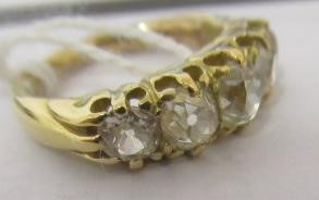 A FIVE STONE DIAMOND HALF HOOP RING, the old cut stones each of approximately 0.25cts, all claw set Image