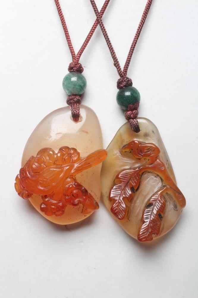 TWO CHINESE CARVED HARDSTONE PENDANTS on silk cords with aventurine bead 'ojime' (Est. plus 24% Image