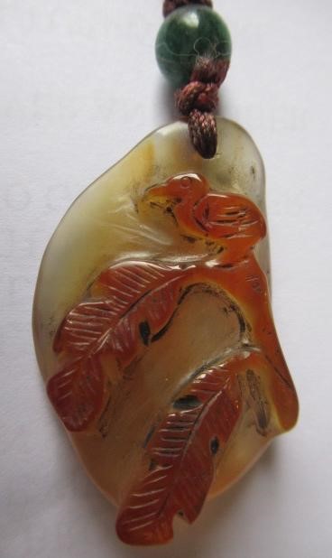 TWO CHINESE CARVED HARDSTONE PENDANTS on silk cords with aventurine bead 'ojime' (Est. plus 24% Image