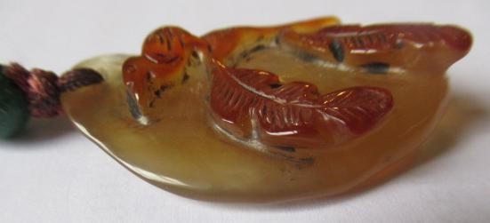 TWO CHINESE CARVED HARDSTONE PENDANTS on silk cords with aventurine bead 'ojime' (Est. plus 24% Image