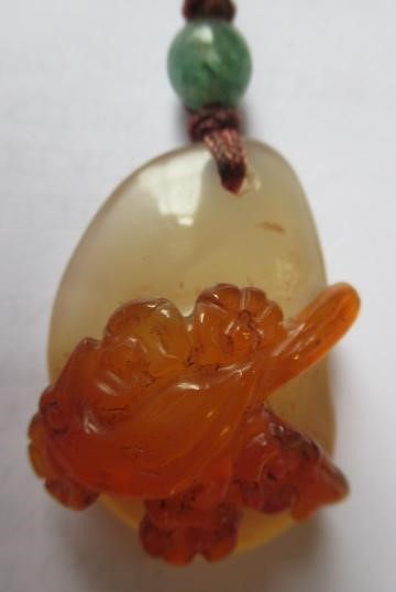 TWO CHINESE CARVED HARDSTONE PENDANTS on silk cords with aventurine bead 'ojime' (Est. plus 24% Image
