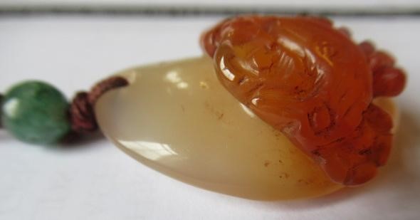 TWO CHINESE CARVED HARDSTONE PENDANTS on silk cords with aventurine bead 'ojime' (Est. plus 24% Image